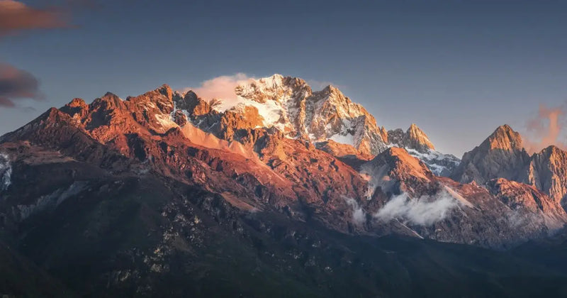 Golden sunrise hitting the peaks of Jade Dragon Snow Mountain (Rizhao Jinshan).