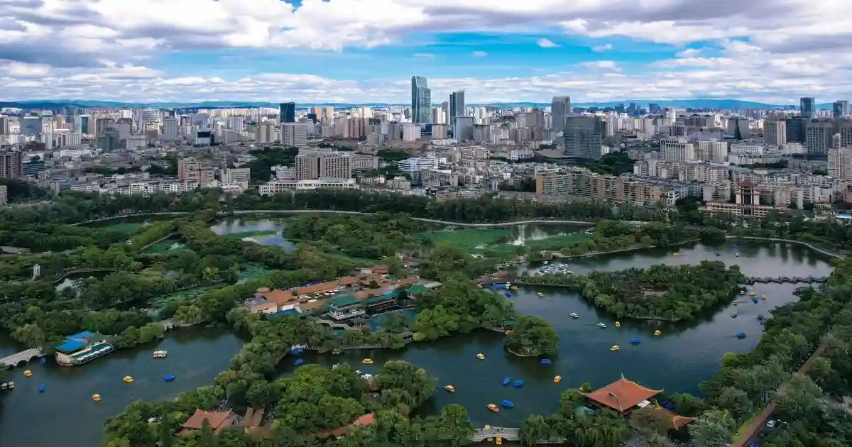 Modern skyline of Kunming, the "Spring City" of China, under a clear blue sky.