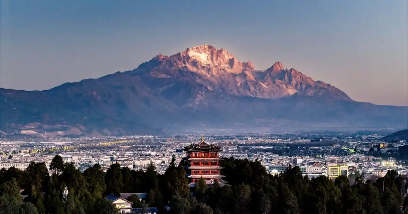 Stunning panoramic view of Lijiang Old Town with Jade Dragon Snow Mountain backdrop.