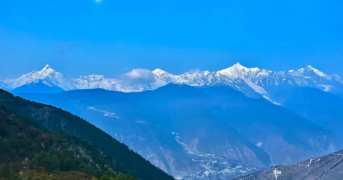 Majestic panoramic view of the Meili Snow Mountain range in Yunnan.