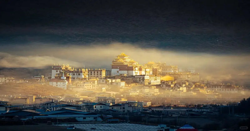 Enigmatic morning mist surrounding the golden roofs of Sumtseling Monastery in Shangri-La.