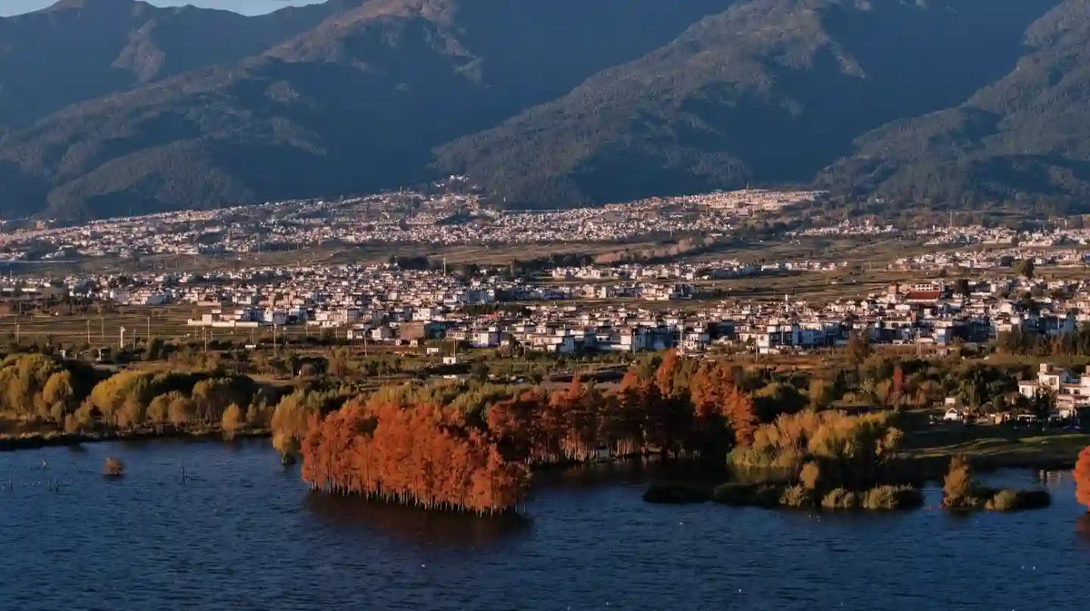 Distant view of Cangshan Mountain peaks across Erhai Lake from Shuanglang Ancient Town.